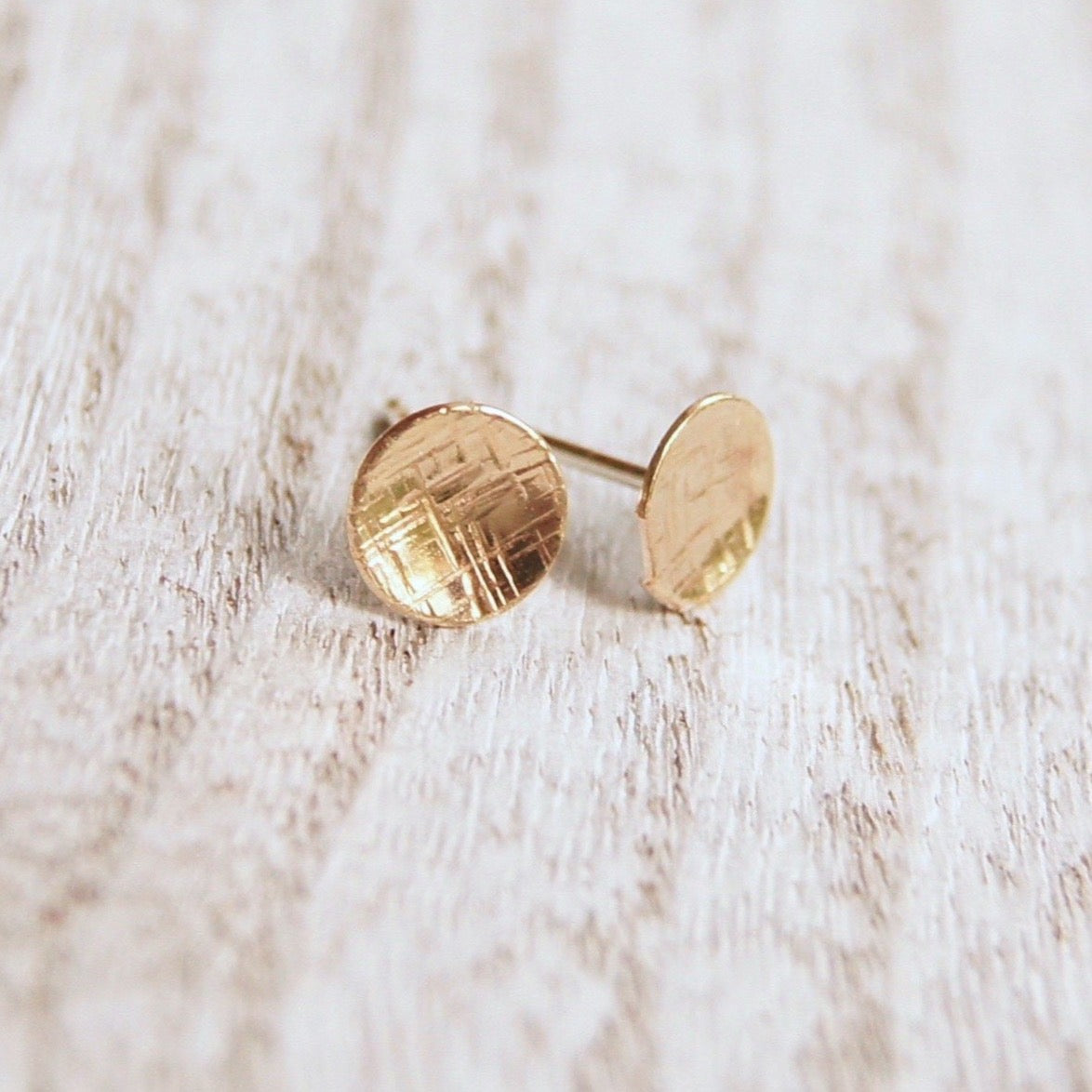 Small round silver or gold studs