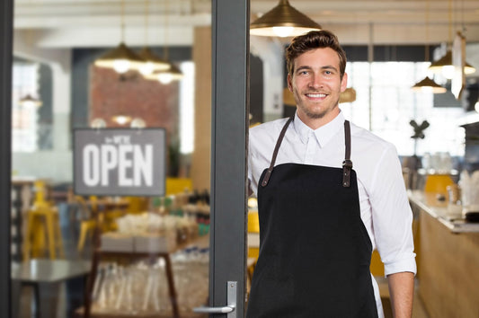 K0015GB | Grembiule da Lavoro in Canvas/ Vera Pelle pieno fiore, volanata. Colore Corda/Testa Moro. Accessori Nickel Anticato. Dimensioni: cm 70 x 90 x 0,5. Confezione: Polybag - Velora Luxury Fashion