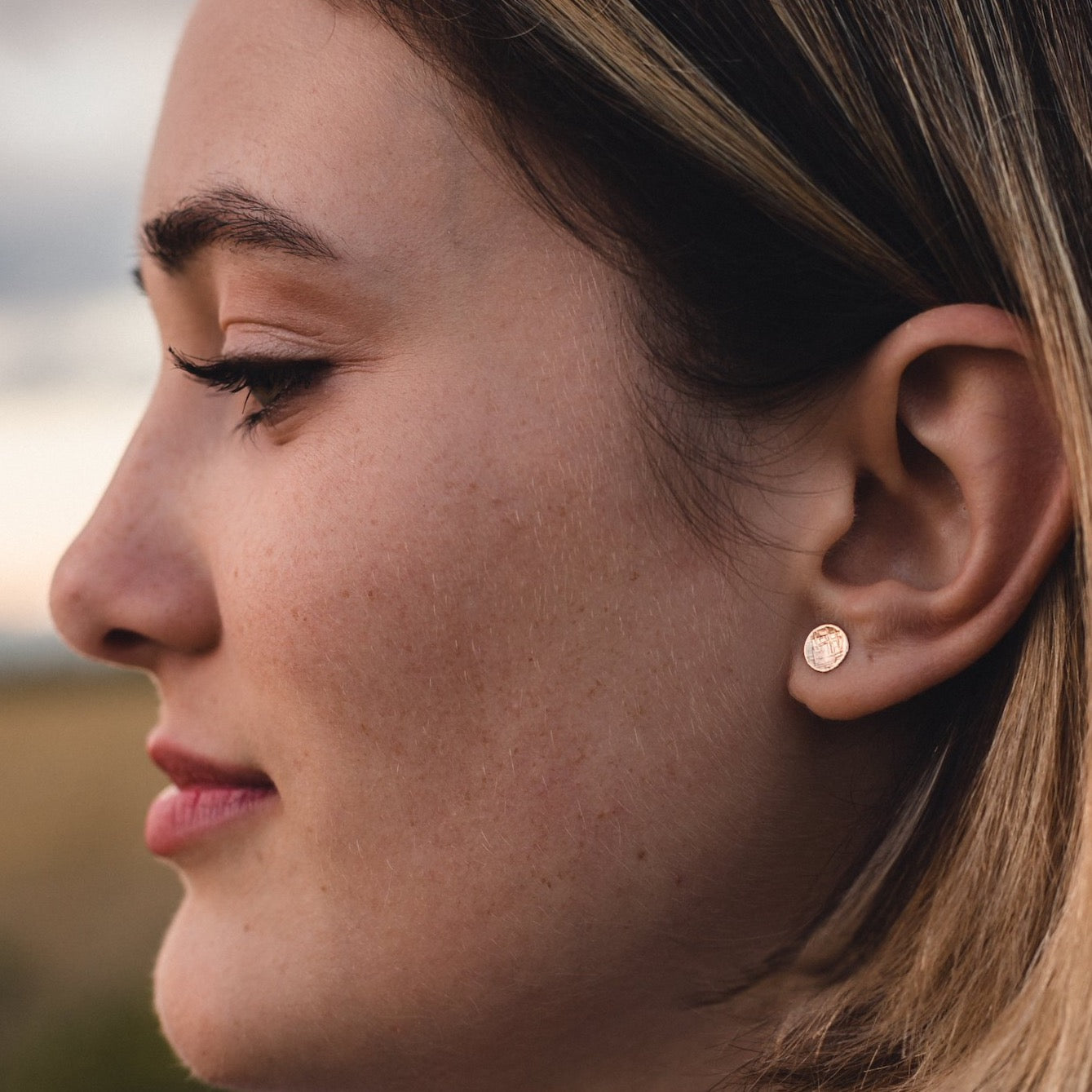 Small round silver or gold studs